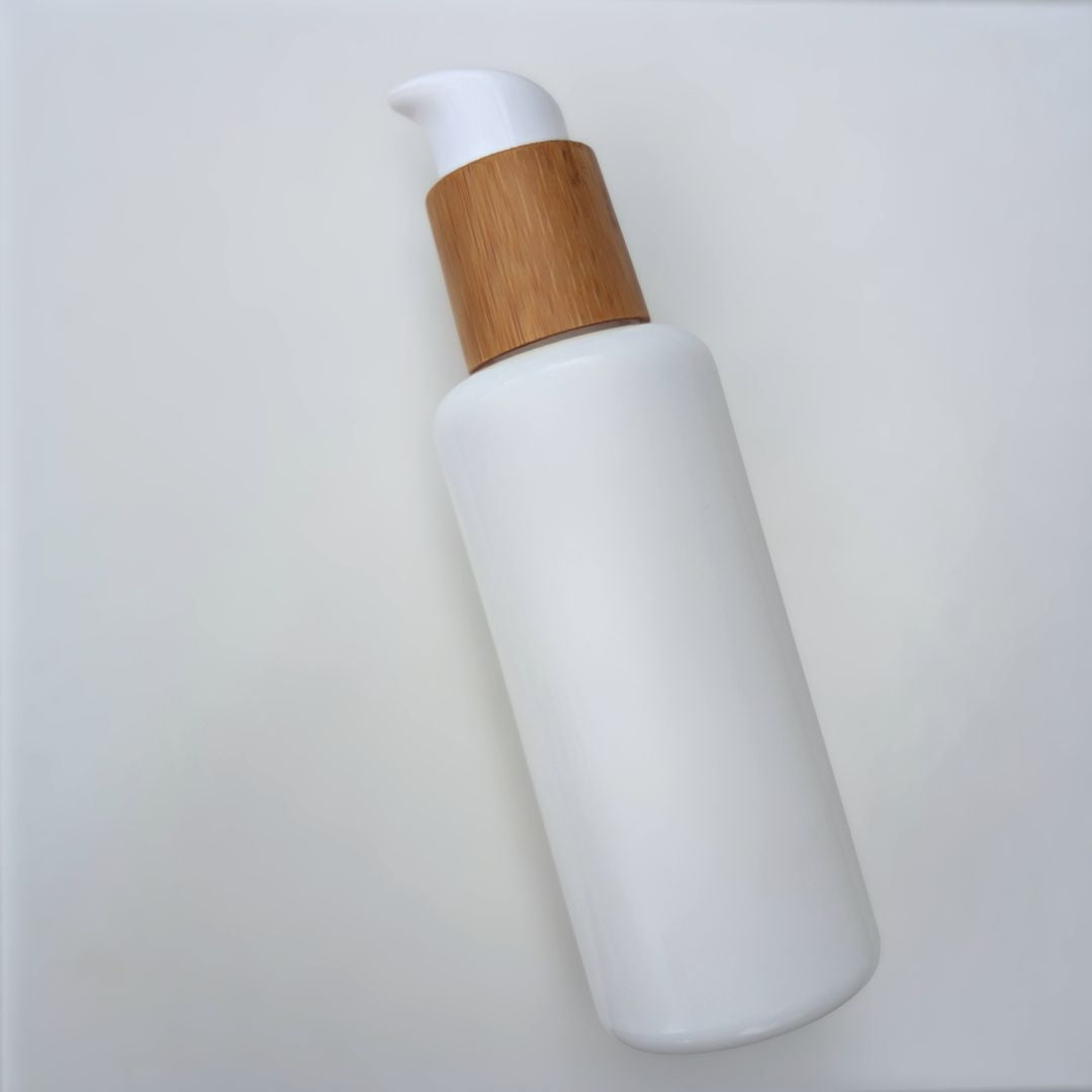 4 oz cleanser bottle in white opal glass with wood bamboo twist pump for professional private label skincare