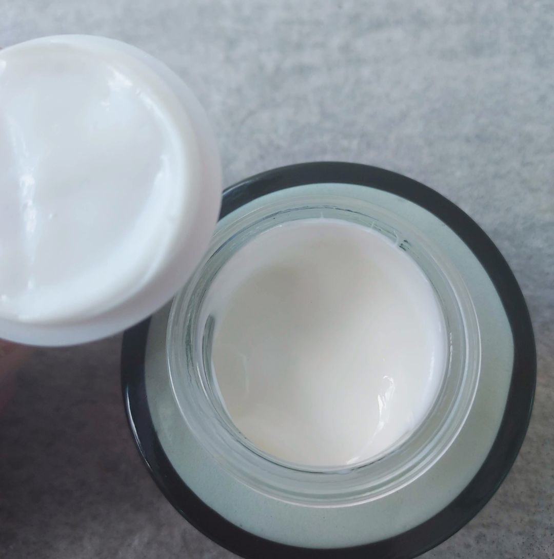 view of green glass moisturizer jar filled with cream - Ataliene Private Label Skincare