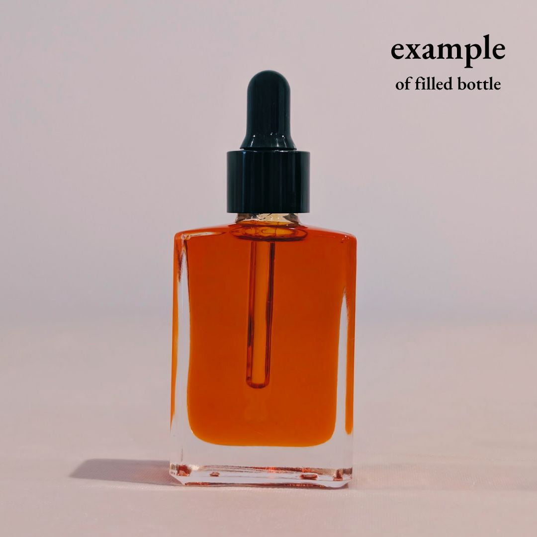 clear square glass bottle with black dropper 30ml filled with red face oil for private label skincare