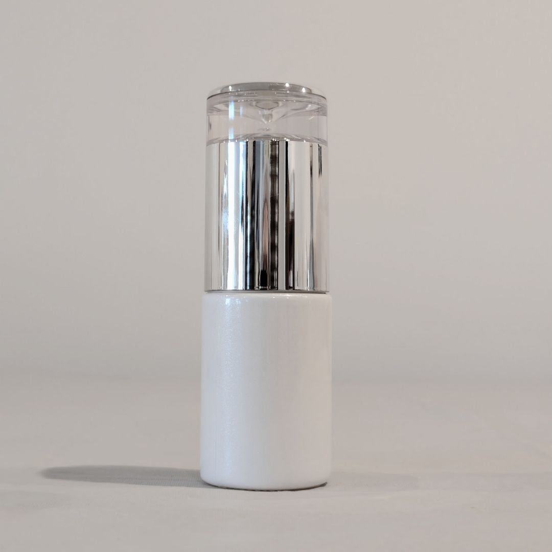 White and silver cylindrical glass pump bottle 30 ml for medical grade private label skincare - Ataliene Private Label