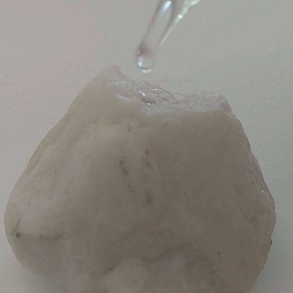 video of ataliene vitamin C + squalane serum oil dripping from dropper onto rock
